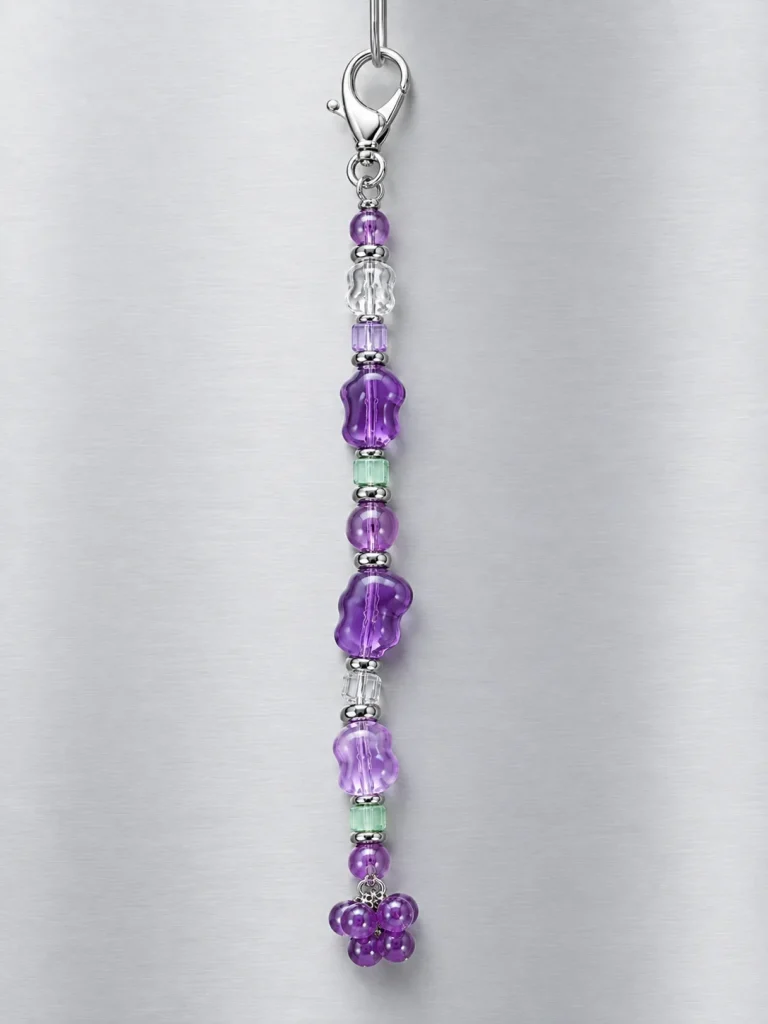 Grape Soda Bag Dangle hanging from its clasp