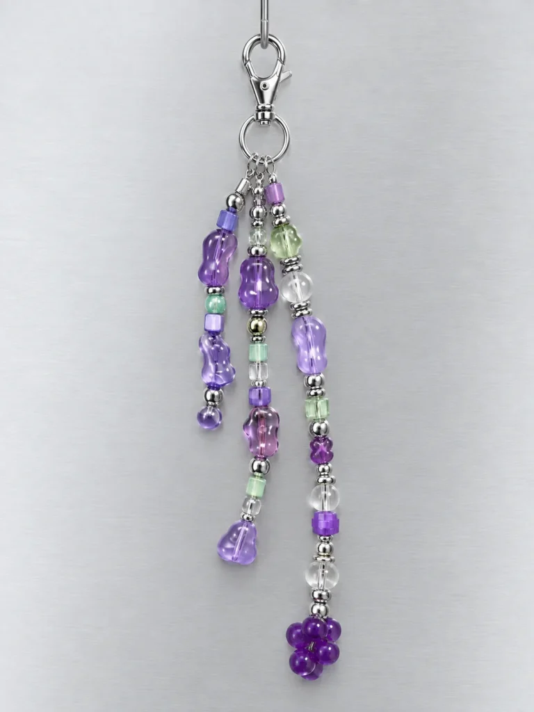 Grape Soda Cluster Charm hanging from its clasp