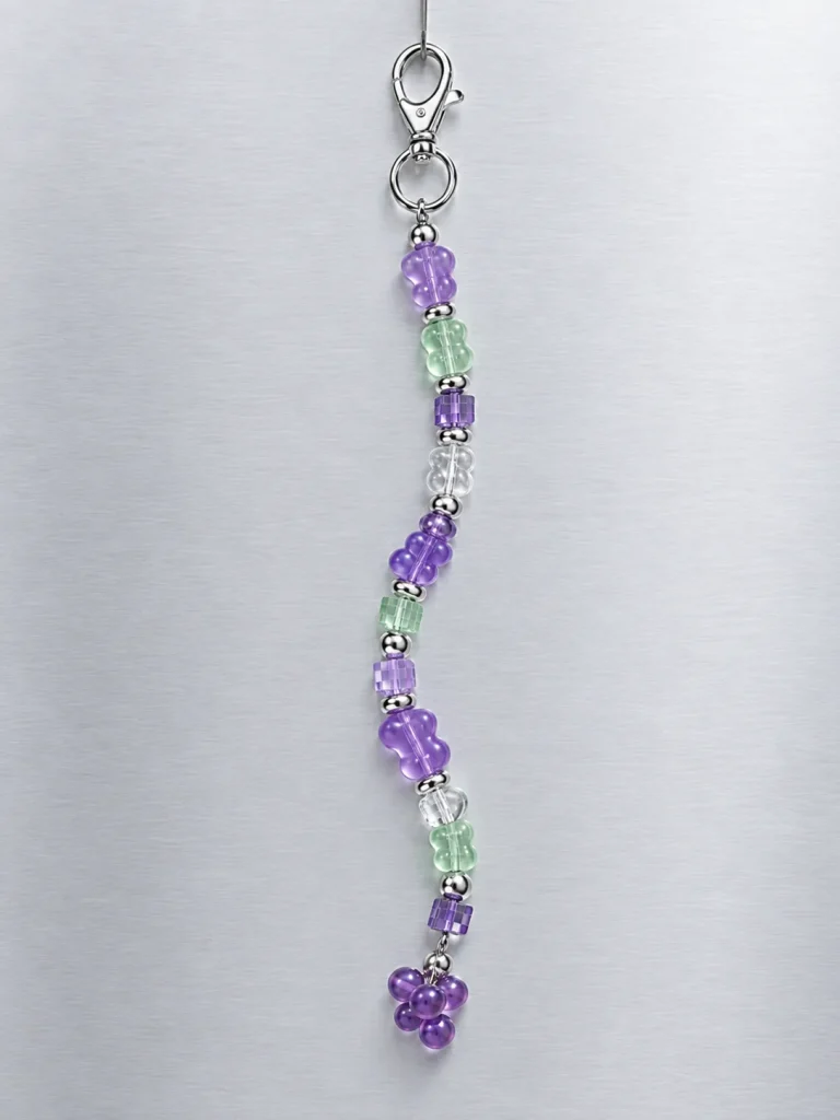 Grape Soda Earbud Case Charm hanging from its clasp
