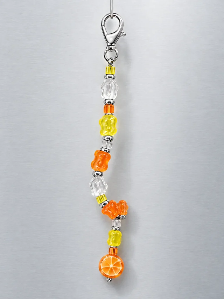 Tangerine Glitch Bag Dangle hanging from its clasp