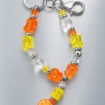Tangerine Glitch Taschenanhänger, flach ausgelegt