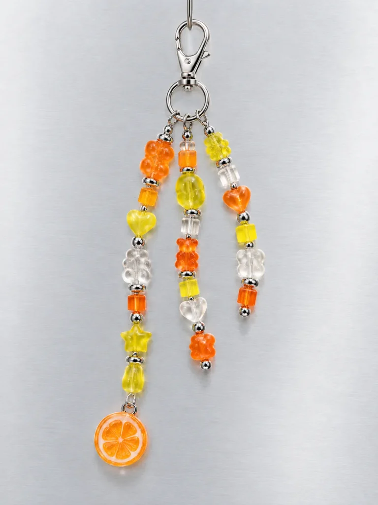 Tangerine Glitch Cluster Charm hanging from its clasp