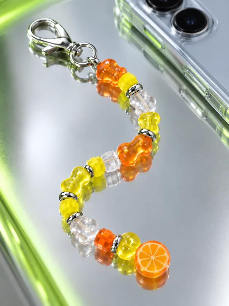 Tangerine Glitch Earbud Case Charm close up