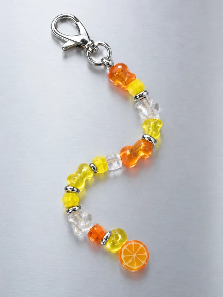 Tangerine Glitch Earbud Case Charm, laid flat