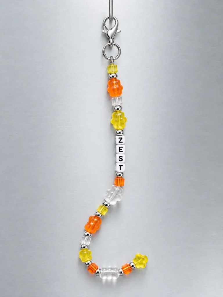 Tangerine Glitch Pixel Strand hanging from its clasp
