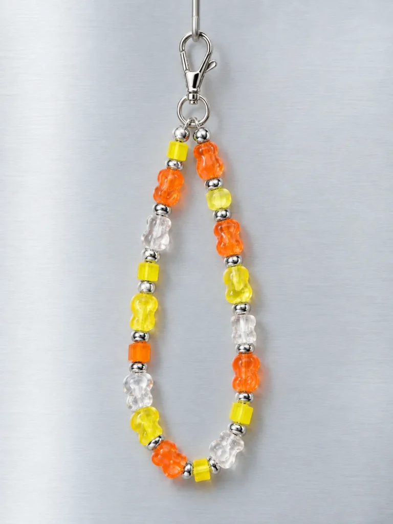Tangerine Glitch Wrist Loop hanging from its clasp
